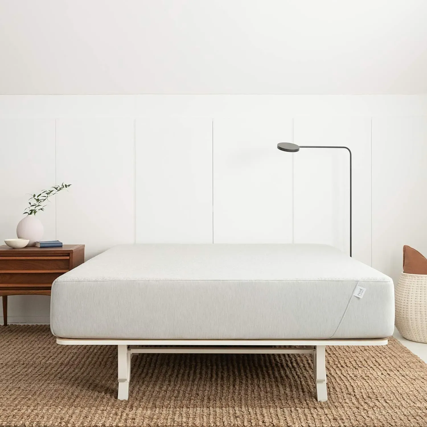 Tuft & Needle Nod Hybrid Mattress with ventilated fabric cover on bedroom frame
