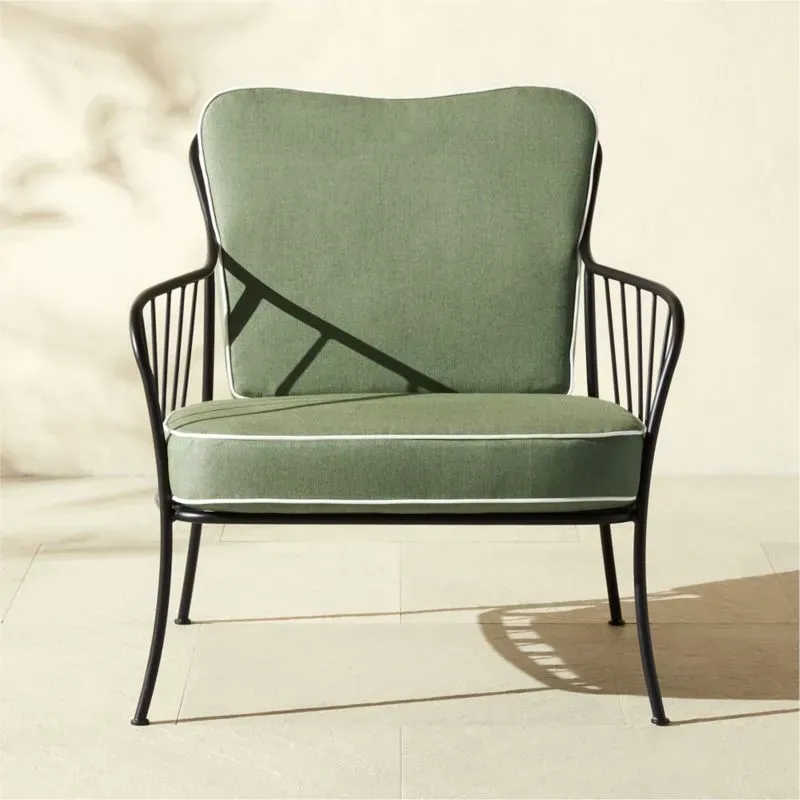 CB2 Welling black metal outdoor lounge chair with Sunbrella cushion on a modern patio