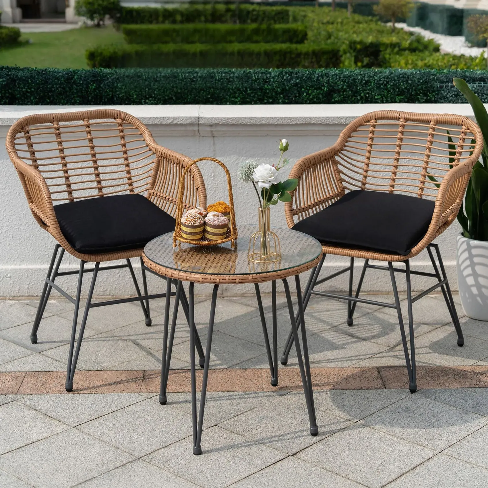 Tappio 3-piece outdoor wicker bistro set with glass tabletop and thick cushioned chairs on a balcony