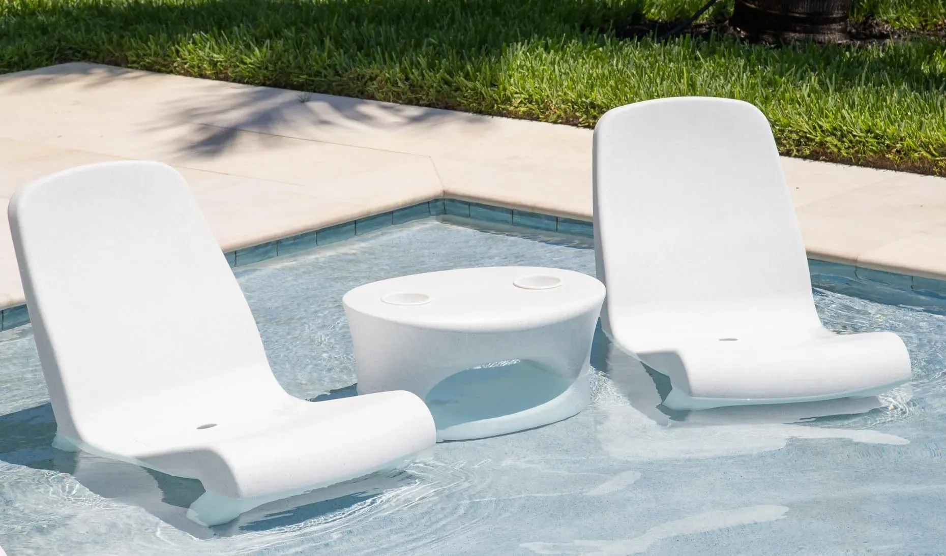 Tenjam Freelo in-pool lounge chair on a residential pool sun shelf